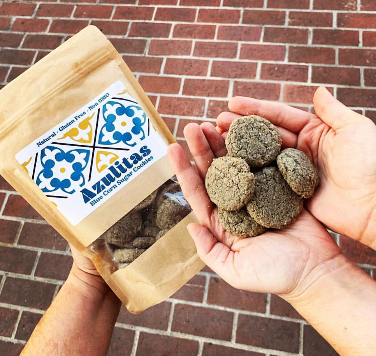 People holding azulita cookies in their hands, as well as an unopened package of azulitas.