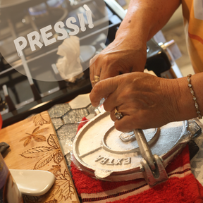 Person using a hand press with the text "press"